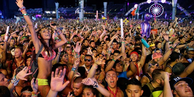In this Saturday, June 21, 2014 file photo, carnival-goers dance to music by Krewella at the Electric Daisy Carnival in Las Vegas.