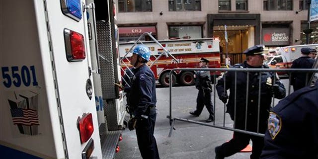 Dec. 14: Emergency personnel gather outside of a building where there was an elevator accident in New York. A woman was killed when her foot or leg became caught in an elevator's closing doors, New York City fire officials said Wednesday.