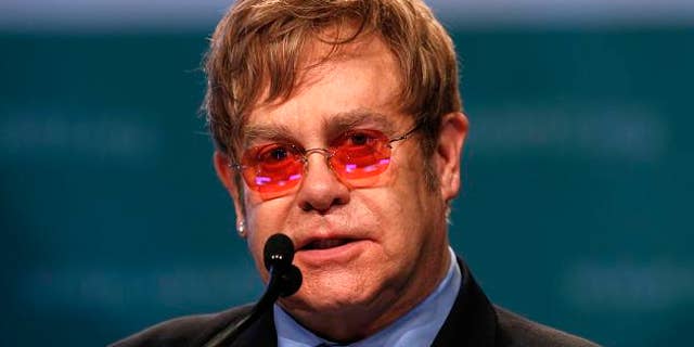 Musician Elton John delivers the keynote speech at the International AIDS 2012 Conference in Washington July 23, 2012. REUTERS/Kevin Lamarque (UNITED STATES - Tags: HEALTH POLITICS ENTERTAINMENT)