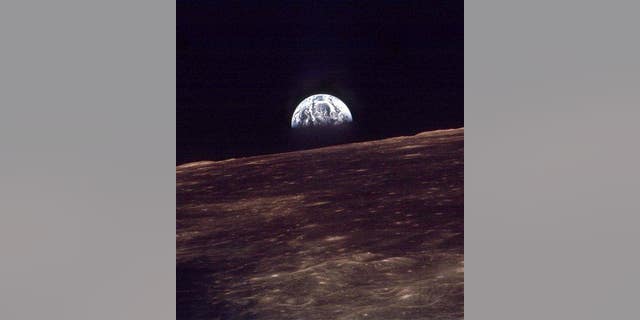 In this 1968 photo, the Earth rises over the horizon of the moon during the Apollo 8 mission.