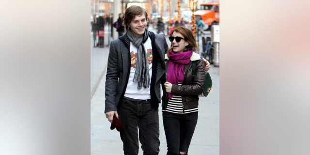 Evan Peters and Emma Roberts walk together in New York City.