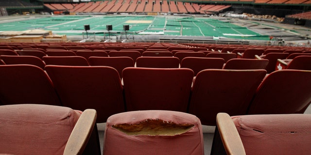 FILE - In this May 21, 2012, file photo, rows of dirty, tattered seats ring the Astrodome in Houston. Once touted as the Eighth Wonder of the World, the nation's first domed stadium sits quietly gathering dust and items for storage. The National Trust for Historic Preservation put the Astrodome on its 2013 list of 11 Most Endangered Historic Places. The Astrodome was the worldâs first domed, air-conditioned stadium and needs a viable plan to be reused to avoid demolition. (AP Photo/Pat Sullivan, File)