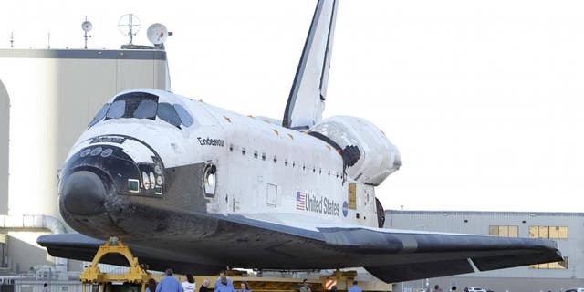 Space shuttle Endeavour is transported from the Orbital Processing Facility to the Vehicle Assembly Building where the orbiter will be connected to the external fuel tank and twin solid rocket boosters at the Kennedy Space Center in Cape Canaveral, Fla., Monday, Feb. 28, 2011. Endeavour is schedule to launch April 19.(AP Photo/John Raoux)