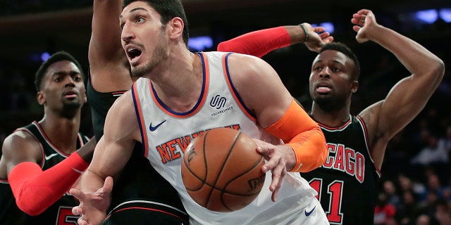 FILE - In this March 19, 2018, file photo, New York Knicks center Enes Kanter (00) drives to the basket against the Chicago Bulls during the first quarter of an NBA basketball game in New York. Kanter informed the Knicks on Friday, June 29, 2018, that he was opting into his contract for next season, rather than becoming a free agent. (AP Photo/Julie Jacobson, File)