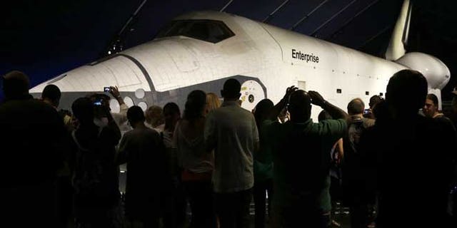July 10, 2013: Visitors look at the space shuttle Enterprise in its newly completed pavilion on the deck of the Intrepid Sea, Air & Space Museum in New York.