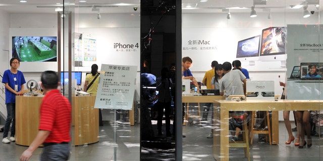 July 21, 2011: A man walks past windows of a shop masquerading as a bona fide Apple store in downtown Kunming, in southwest China's Yunnan province.
