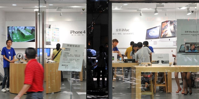July 21, 2011: A man walks past windows of a shop masquerading as a bona fide Apple store in downtown Kunming, in southwest China's Yunnan province.