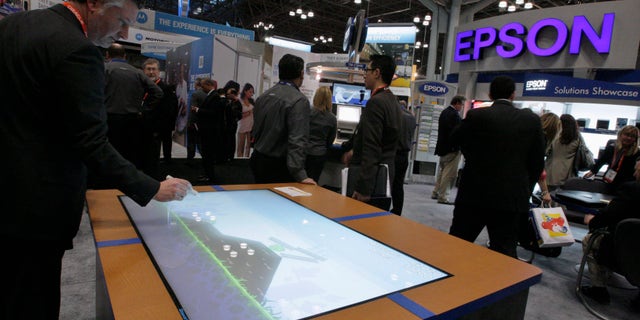 File photo. A man visits the Epson stand at the National Retail Federation's Annual Convention and Expo in New York January 2012.