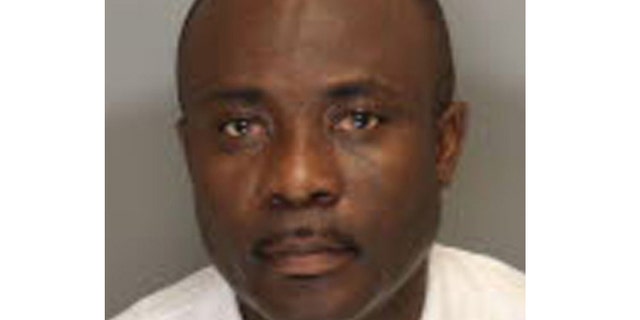 This undated booking photo provided by the Cobb County Sheriff in Marietta, Ga., shows Ernest Addo, 48.