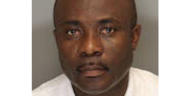 This undated booking photo provided by the Cobb County Sheriff in Marietta, Ga., shows Ernest Addo, 48.