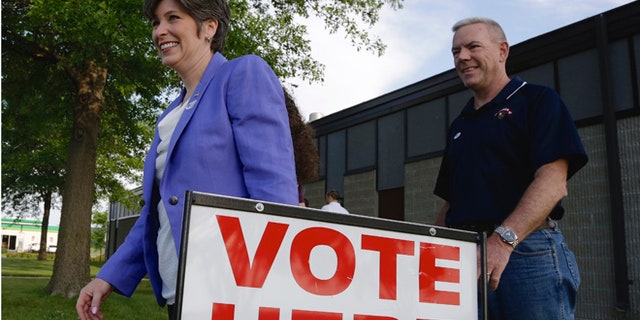 June 3, 2014: GOP Senate candidate Joni Ernst and husband Gail, right, leave a polling station in Red Oak, Iowa.