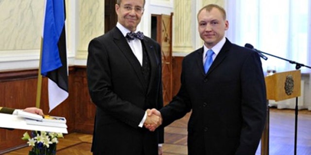 This 2010 photo shows Eston Kohver, right, receivning a decoration from Estonia's President Toomas Hendrik.