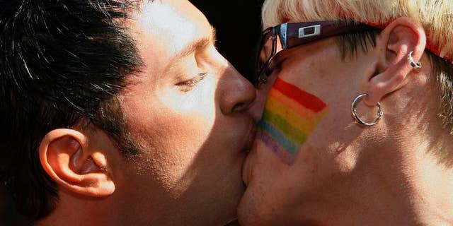 FILE - In this Saturday, Aug. 12, 2006 file photo, Gay pride parade participants kiss in the streets of Tallinn, Estonia. Estonia's Parliament narrowly passed legislation to legalize gay partnerships on Thursday, Oct. 9, 2014, making it the first former Soviet republic to do so. (AP Photo/AFI, Toms Kalnins, File)