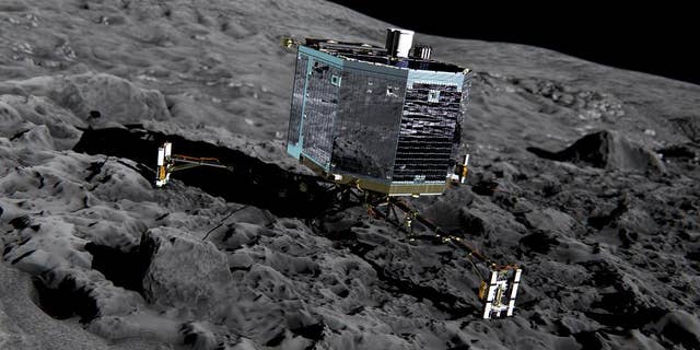 This artist impression from Dec. 2013 by ESA /ATG medialab , publicly provided by the European Space Agency, ESA, shows Rosetta’s lander Philae (front view) on the surface of comet 67P/Churyumov-Gerasimenko. The comet lander Philae has awakened from a seven-month hibernation and managed to communicate with Earth for more than a minute, the European Space Agency said Sunday June 14, 2015. The probe became the first spacecraft to land on a comet when it touched down on the icy surface of 67P/Churyumov-Gerasimenko in November. Shortly after its historic landing, Philae managed to conduct experiments and send data to Earth for about 60 hours before its batteries were depleted and it was forced into hibernation. (ESA/ATG medialab/ESA via AP)
