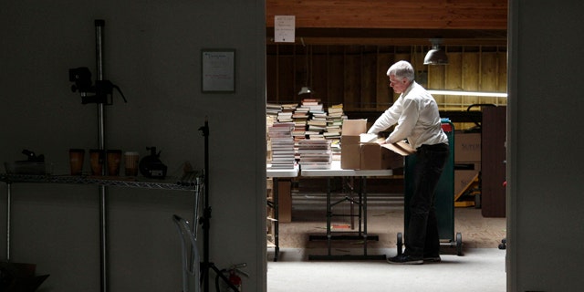 July 21, 2011: Mark, who did not give his last name, unpacks boxes of books at the Internet Archive's Physical Archive warehouse in Richmond, Calif. Saving a copy of every Web page ever posted sounds like an ambitious life's work, but Brewster Khale has decided digital isn't enough.