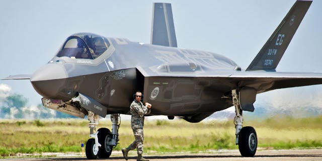 FILE: A 33rd Fighter Wing aircraft maintainer moves by the Department of Defense's newest aircraft, the U.S. Air Force F-35 Lightning II joint strike fighter (JSF), before giving the pilot an order to taxi the aircraft at Eglin Air Force Base, Fla.