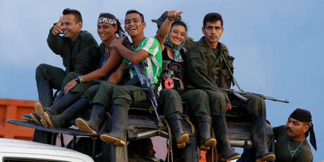 Rebels of the Revolutionary Armed Forces of Colombia (FARC) arrive to El Diamante in southern Colombia, Friday, Sept. 16, 2016. FARC rebels are gathering for a congress to discuss and vote on a peace accord reached with the Colombian government to end five decades of war. Historically secretive, this congress is the first one open to civilians. (AP Photo/Ricardo Mazalan)