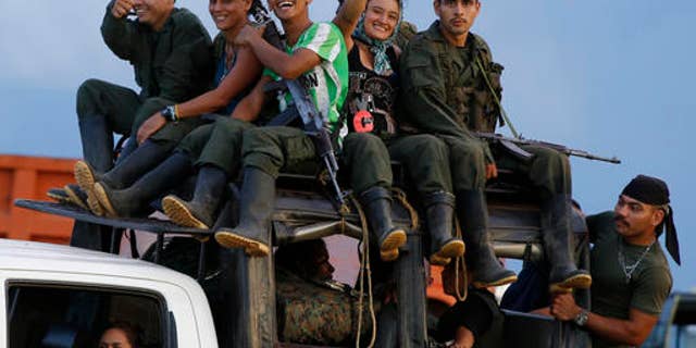 Rebels of the Revolutionary Armed Forces of Colombia (FARC) arrive to El Diamante in southern Colombia, Friday, Sept. 16, 2016. FARC rebels are gathering for a congress to discuss and vote on a peace accord reached with the Colombian government to end five decades of war. Historically secretive, this congress is the first one open to civilians. (AP Photo/Ricardo Mazalan)