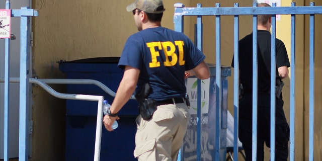 MIAMI - OCTOBER 21: An agent with the F.B.I. is seen outside the American Therapeutic Corp. building on October 21, 2010 in Miami, Florida. Federal agents raided the building this morning during an operation that resulted in the arrest of four in what is being called one of the nation's biggest Medicare fraud cases. They are being charged with scheming to fleece $200 million from the Medicare program by billing for bogus mental health services. (Photo by Joe Raedle/Getty Images)