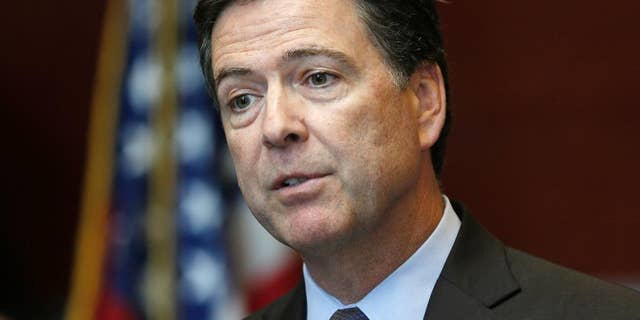FILE - In this Sept. 23, 2014 file photo, FBI Director James Comey speaks at the FBI Albany Field Office in Albany, N.Y. The U.S. believes it has identified the British-accented masked man in the videos depicting the beheadings of two American journalists and a British aid worker, the FBI director says. Comey told reporters at the bureau’s headquarters he would not reveal the man’s name or nationality. (AP Photo/Mike Groll, File)