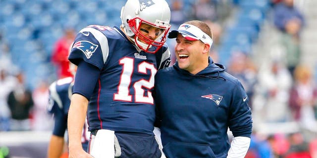 Oct 26, 2014; Foxborough, MA, USA; New England Patriots quarterback Tom Brady has a laugh with offensive coordinator Josh McDaniels before the game between the New England Patriots and the Chicago Bears at Gillette Stadium. Mandatory Credit: Winslow Townson-USA TODAY Sports