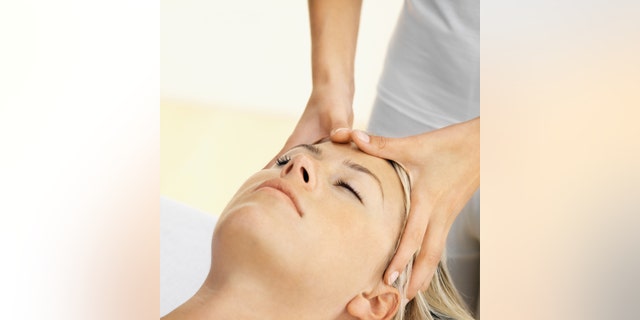 Close up of a woman receiving a head massage