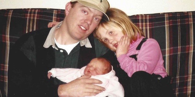 This 1999 family photo provided by Lori Taylor shows her brother Patrick Hardison, with his two daughters, Averi, left, and Alison in Senatobia, Miss.