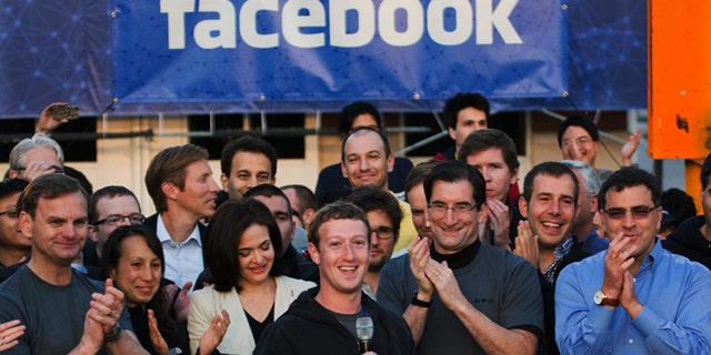 FILE - In this May 18, 2012 file photo provided by Facebook, Facebook founder, Chairman and CEO Mark Zuckerberg, center, rings the Nasdaq opening bell from Facebook headquarters in Menlo Park, Calif. (AP Photo/Nasdaq via Facebook, Zef Nikolla, File)