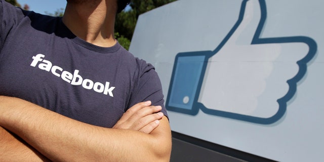 A Facebook worker waits for friends to arrive outside of Facebook headquarters in Menlo Park, Calif., Friday, Aug. 17, 2012. Facebook stock is trading at $19 and has lost half its market value since its May public offering. (AP Photo/Paul Sakuma)