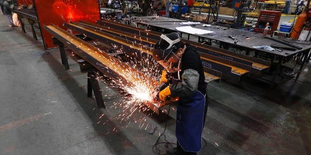 In this Thursday, Jan. 23, 2014 photo, Jesus Rodriguez grinds steel at the IDEAL Group in Detroit. The Commerce Department releases factory orders for March on Friday, May 2, 2014. (AP Photo/Paul Sancya)