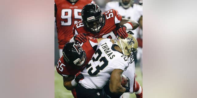 FILE - In this Nov. 21, 2013, file photo, New Orleans Saints running back Pierre Thomas (23) is hit by Atlanta Falcons linebackers Joplo Bartu (59) and Paul Worrilow (55) during the first half of an NFL football game in Atlanta. Sean Weatherspoon's season-ending Achilles injury will put even more responsibility on Worrilow and Bartu. (AP Photo/David Goldman, File)