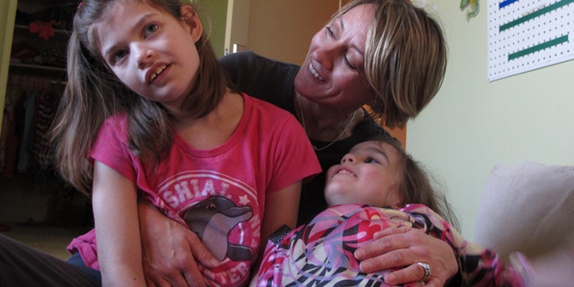 Feb. 27, 2015: Alexis Carey, left, 10, sits with her mother Clare Carey, center, and her sister Alanis Carey, right, 5, in Boise, Idaho. (AP)