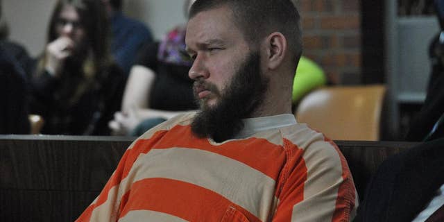 Kyle Flack, 28, of Ottawa, who is charged in connection with the killing of three adults and an 18-month-old girl in 2013, listens to testimony, Tuesday, March 11, 2014, in Ottawa, Kan. Flack, 28, is charged with capital murder and other charges in the slaying of four people at a farm in rural eastern Kansas last spring. (AP Photo/The Ottawa Herald, Abby Eckel, Pool)