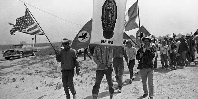 FILE - In this April 7, 1966 file photo, grape strikers on a 300-mile march from Delano, Calif., approach their goal, the Capitol in Sacramento.