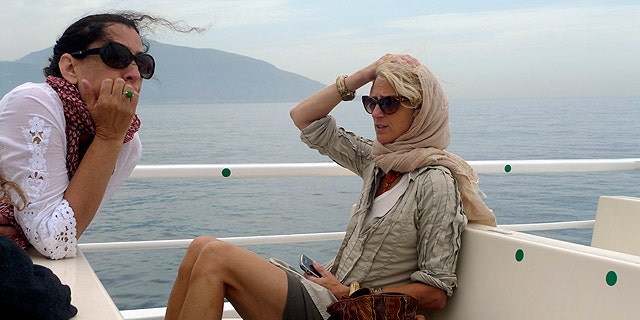 This undated photo courtesy of Nanette Lepore shows designer Nanette Lepore, right, on a boat with her cousin, Lisa Lepore, as they travel from Naples to the Amalfi Coast in Italy. Fashion designers often live the jet-set life they love to mimic on their runways. They travel for business, they travel for pleasure. They are always looking for inspiration, and they take a lot of photographs. (AP Photo/Nanette Lepore)