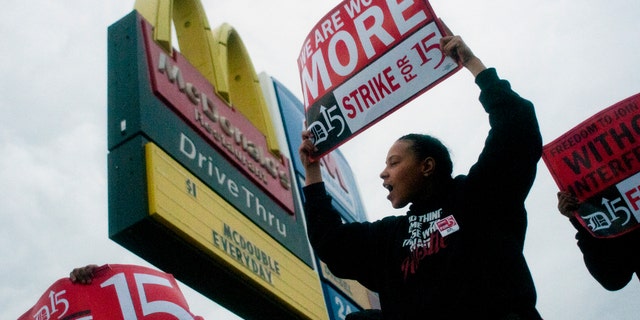 Fast-food worker Michelle Osborn, 23, of Flint, Mich. shouts out chants as she and a few dozen others strike outside of a McDonald's restaurant on Wednesday, July 31, 2013 in Flint. A few thousand fast-food workers in seven cities took to the streets demanding better pay, the right to unionize and a more than doubling of the federal minimum hourly wage from $7.25 to $15. (AP Photo/The Flint Journal, Jake May)