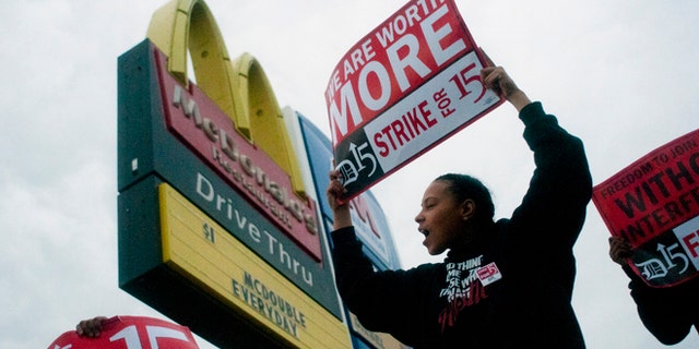 Fast-food worker Michelle Osborn, 23, of Flint shouts out chants as she and a few dozen others strike outside of McDonald's on Wednesday, July 31, 2013 in Flint. Some fast food restaurant workers have walked off the job in the Detroit area as part of an effort to push for higher wages. Organizers say they began the walkout at restaurants in Lincoln Park and Southfield on Tuesday night. Workers in Flint hit the street Wednesday outside a McDonald's, saying they want wages "super-sized." Workers want $15 and hour, better working conditions and the right to unionize. The restaurant industry says higher wages would hurt job creation. The actions follow strikes this week in other parts of the country. (AP Photo/The Flint Journal, Jake May) LOCAL TV OUT; LOCAL INTERNET OUT
