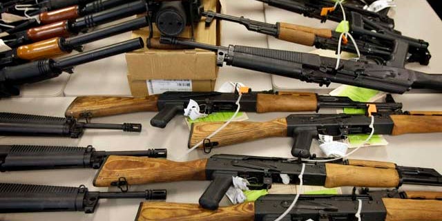 This Tuesday, Jan. 25, 2011 picture shows part of a cache of seized weapons displayed at a news conference in Phoenix. The ATF is under fire over a Phoenix-based gun-trafficking investigation called "Fast and Furious," in which agents allowed hundreds of guns into the hands of straw purchasers in hopes of making a bigger case. Two of those weapons were found in December at the fatal shooting of U.S. Border Patrol agent Brian Terry, igniting a scandal that has resulted in a congressional investigation and review by the Justice Department's Office of Inspector General. (AP Photo/Matt York)