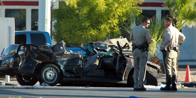 Sept. 13, 2012: Police officers stands near a vehicle involved in a crash at a bus stop.