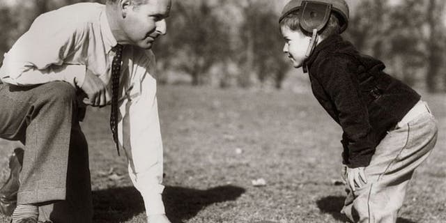 UNITED STATES - Circa 1930s: Father & Son Playing Football. (Photo by H. Armstrong Roberts/Retrofile/Getty Images)
