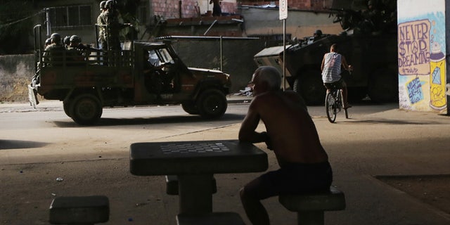 Brazilian soldiers patrol in the Complexo da Mare favela complex, one of the largest favela complexes in Rio, on March 2, 2015 in Rio de Janeiro, Brazil. The Brazilian government has occupied the complex with federal forces since before the start of the 2014 World Cup. (Photo by Mario Tama/Getty Images)