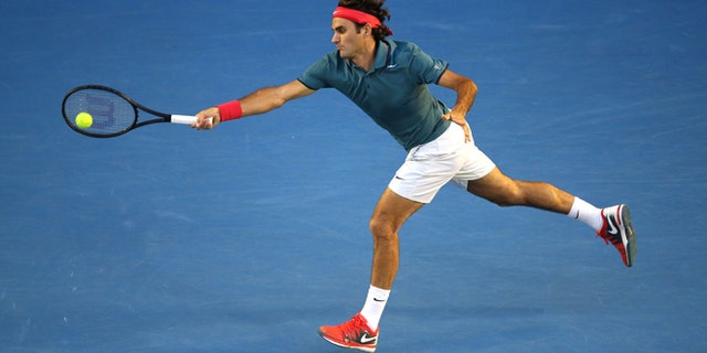 MELBOURNE, AUSTRALIA - JANUARY 22: Roger Federer of Switzerland serves in his quarterfinal match against Andy Murray of Great Britain during day 10 of the 2014 Australian Open at Melbourne Park on January 22, 2014 in Melbourne, Australia. (Photo by Clive Brunskill/Getty Images)