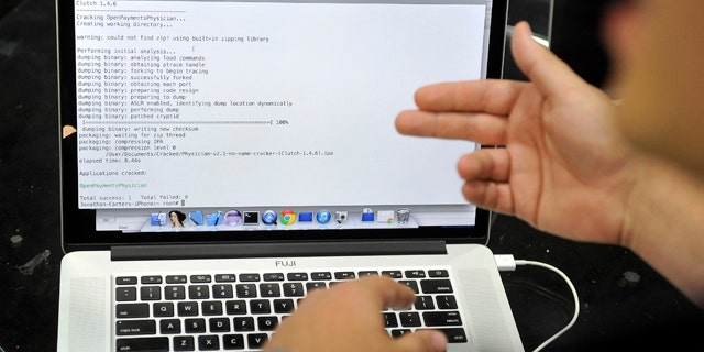 August 6, 2014: Joe Abbey, Arxan Technologies' director of software engineering, displays on his computer how he hacked into a phone app during a demonstration at the Black Hat USA 2014 cyber security conference, in Las Vegas.