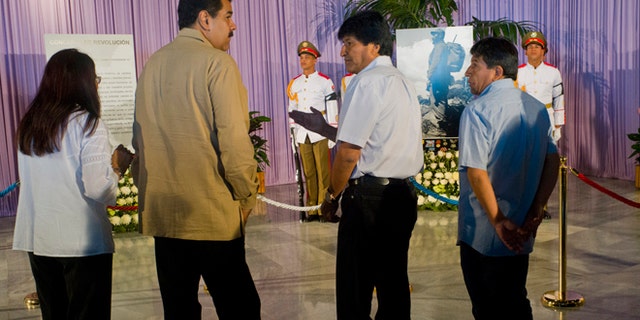Venezuela's first lady Cilia Flores, from left, her husband President Nicolas Maduro, and Bolivia's President Evo Morales, visit the memorial site for Fidel Castro at Revolution Plaza in Havana, Cuba, Tuesday, Nov. 29, 2016. Schools and government offices will be closed Tuesday for a second day of homage to Fidel Castro, with the day ending in a rally on the wide plaza where the Cuban leader delivered fiery speeches to mammoth crowds in the years after he seized power.At left is Venezuela's First Lady Cilia Flores. (AP Photo/Ramon Espinosa)