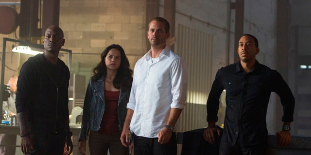 Tyrese Gibson, Michelle Rodriguez, Paul Walker and Chris "Ludacris" Bridges in the film, "Furious 7," directed by James Wan.