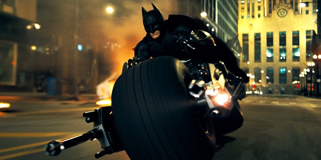 Christian Bale rides a very custom chopper as Batman in a scene from 'The Dark Knight.'