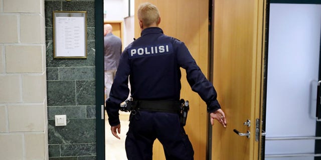 A police officer in Pirkanmaa district court in Tampere Finland, on Tuesday, July 5 2016. Finnish police have released two members of Cuba's national men's volleyball team but are holding six others on suspicion of aggravated rape, an investigator said Monday. (Kalle Parkkinen/Lehtikuva via AP)