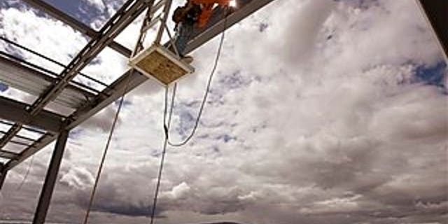 April 13: Welder Andrew Winters works on Facebook's first-ever data center over high desert scrub land in Prineville, Ore. The social networking site chose the high-desert timber town of 10,000 to take advantage of its cool nights and dry air in hopes of making its data center an energy efficiency landmark.