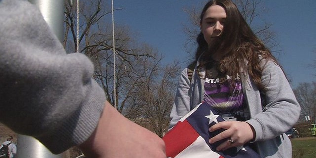 Cara McWhirk, a junior at South Oldham High School in Crestwood, Kentucky, is one of the students that properly lowers, tucks and folds the American flag daily. (WDRB Media)