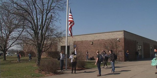 The three high school juniors who tend to the flag daily at South Oldham High School in Crestwood, Kentucky all come from military families. (WDRB Media)